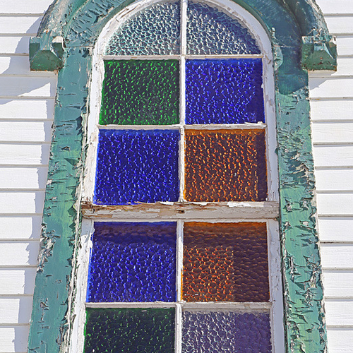 A colorful stained glass window above the main entrance on St. Bridget's Church, Chapel Grove, Kingston Peninsula in…