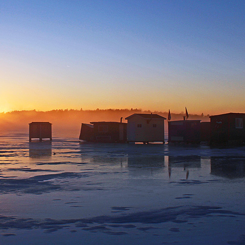 Ice huts silhouetted # sunset along the Kennebecasis River at Rothesay, NB.