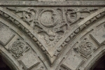 Lower cloister arch, archivolt almohadillado & spandrel relief (moon)