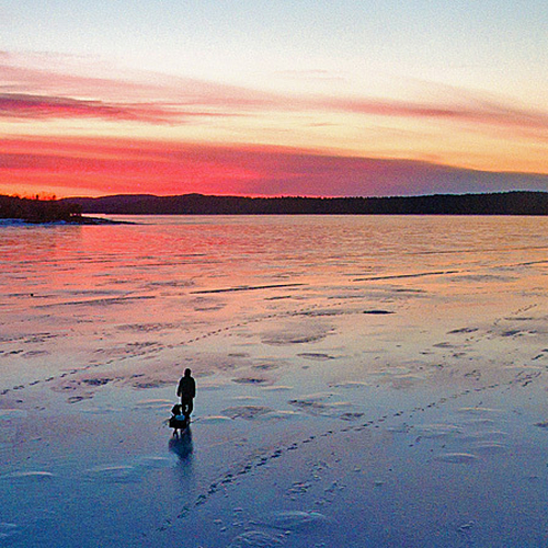 A fisherman heads out for an evening hake fish amid an impressive sunset over the tidal waters of the Kennebecasis Ri…