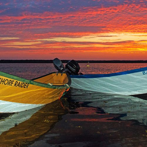 Dulse Dories moored along the beach at Dark Harbour, Grand Manan amid a famous Bay of Fundy Sunset