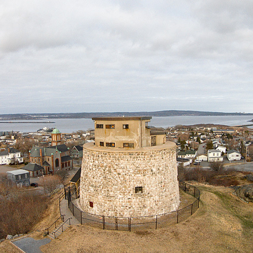 Historic 200 year old Martello Tower with Partridge Island and the city of Saint John visible in the background.