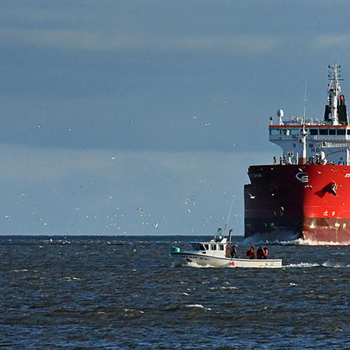 The chemical tanker STI Clapham enters Saint John Harbour as the near shore vessel, Lady II passes by.