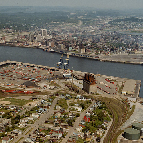 An aerial view of the Port of Saint John in New Brunswick, Canada and showing the homes of the lower westside and wit…