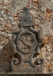 San Antonio, façade portal, cornice finial (left) Franciscan insignia