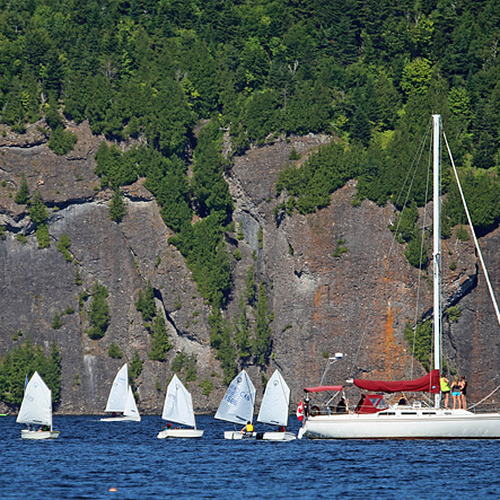 Sailboats participating in the annual RYC Regatta with Long Island and the Minister's Face providing the backdrop.