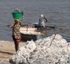 Senegal Lac Rose salt production 9 woman carrying salt from boat to sh