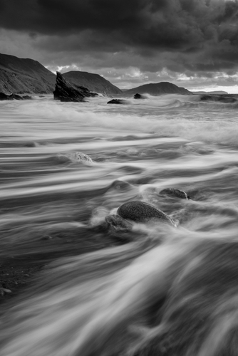 The waves roll in, and then the water heads back, at Traie Vane (White Beach)