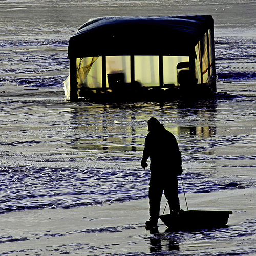 An ice fisherman heads for home at the end of the day @ Renforth Ice Fishing Village in New Brunswick Canada.