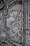 Façade, second story Franciscan insignia (left)