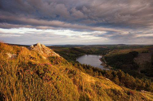 The view over West Baldwin as the top half of Carraghan is briefly bathed in golden evening light.