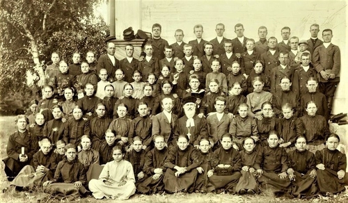 Pastor Staerkel is seated up front, in the midsection. Immediately behind the pastor was the choir director holding u…