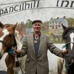 Smiling man with horses at SpancilHill Horse Fair, Co.Clare, Ireland