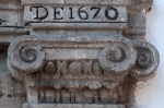 Façade, main portal, right pilaster capital & date