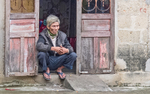 IMG_5169 Crouching man in doorway, Hue, Vietnam