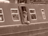 Man at barge window (sepia)