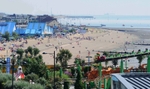 people on beach and on big dipper