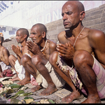 Men make puja at holy lake, India