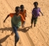 Senegal Fulani three village boys chasing truck  cropped