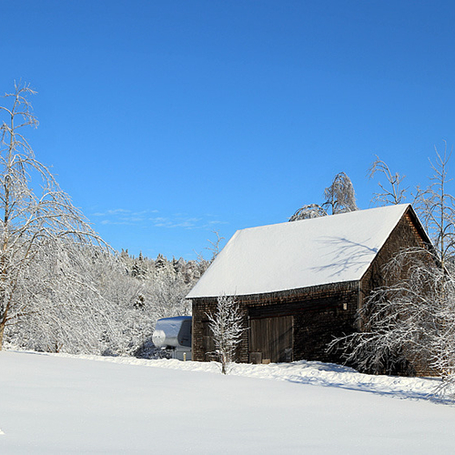 An old barn shows off it's best side on a cold winter's day.