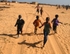 Senegal Fulani Village Fulani children running behind 4x4