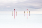 Posts on Southwick beach at high tide