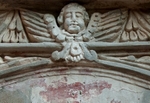 San Juan Bautista, lateral portal architrave detail, cherub