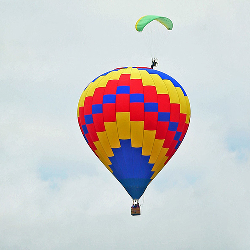 A powered paraglider 'appears' to touchdown on a hot-air balloon at the Atlantic International Balloon Fiesta in Suss…