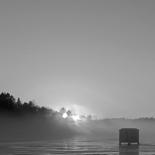 With melting ice, a lone ice shack holds onto the day and the season.
