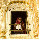 Girl in red saree looking from the Golden Temple, Amritsar, India