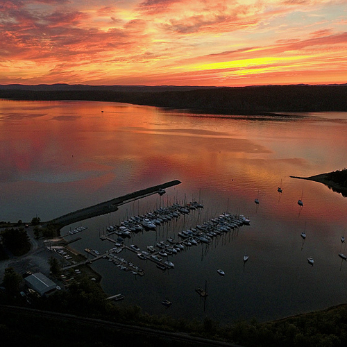 A vivid sunset captured over and reflected upon Kennebecasis Bay in Rothesay, New Brunswick, Canada