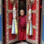 Young Monk in doorway of Temple, Pokhara, Nepal,