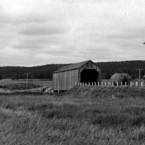 Early, period image of he Sawmill Creek #0.5 covered bridge @ Hopewell Hill with a tractor appoaching and hay bale wa…