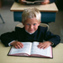 Young Hutterite Boy reading Bible, Alberta, Canada