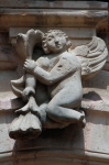 Lower cloister arch keystone, cherub