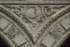 Lower cloister arch, archivolt almohadillado & spandrel relief (moon)
