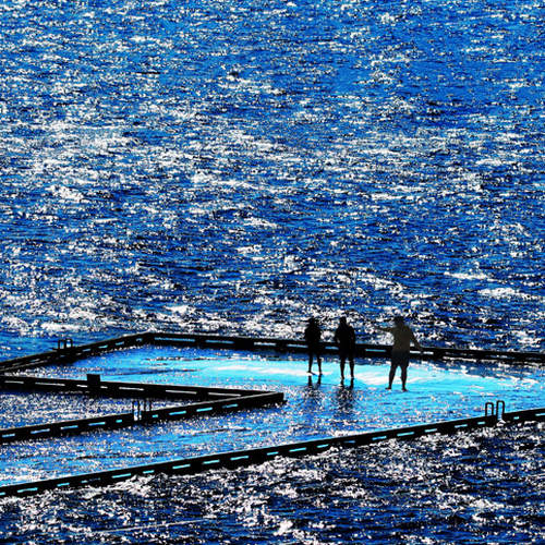 Waders venture on the sunken wharf and swollen Kennebecasis River at high tide on a mid-spring afternoon in Rothesay,…