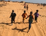 Senegal Fulani Village Fulani children running behind 4x4
