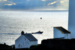 Early  Boat Passes Lighthouse