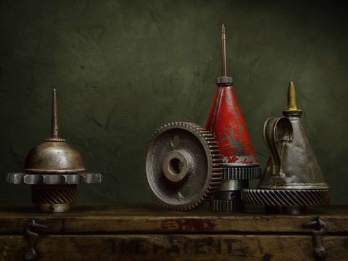 Oil Cans and Cogs. Light-painted still-life, featuring vintage oil cans and gear wheels. Lit with diffused torchlight.