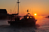 Fishing boat at Looe at sunrise as the mist rises