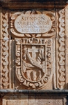 San Juan Bautista, façade placard with Franciscan insignia