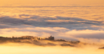 Glengorm Castle looking out over a sea mist at Sunset