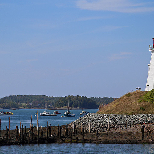 Mulholland Lighthouse on New Brunswick's Campobello Island and with the fishing boats of Lubec, Maine in the bg.