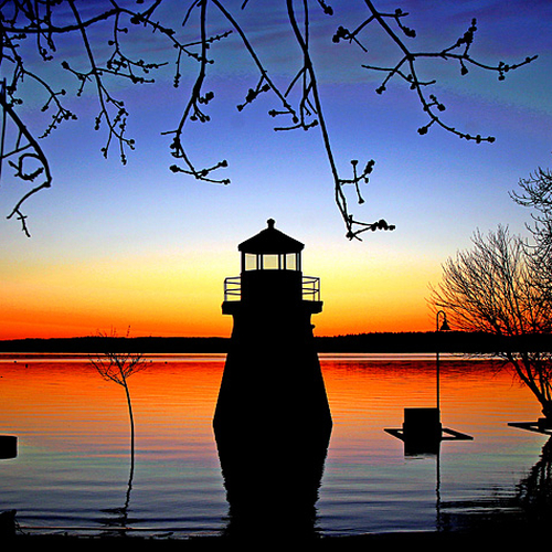 The Renforth Lighthouse knee deep in unchartered floodwaters amid a golden calm twilight.
