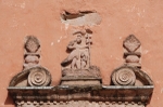 San Juan Bautista, façade, bell-tower base, window cornice relief