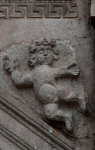 San Andrés, façade portal, right spandrel relief, putto