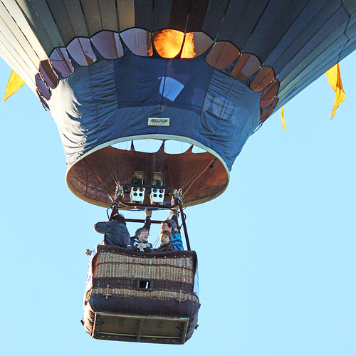 A hot air balloon attempts to get a bit more lift at the Atlantic International Balloon Festival and as a ride nears…