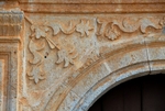 La Asunción, façade portal, left spandrel relief