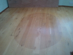 A picture of a hardwood floor faded by the sun,